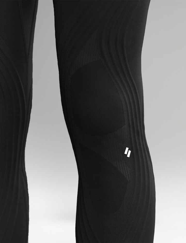 Black leggings with a brand logo on a gray background